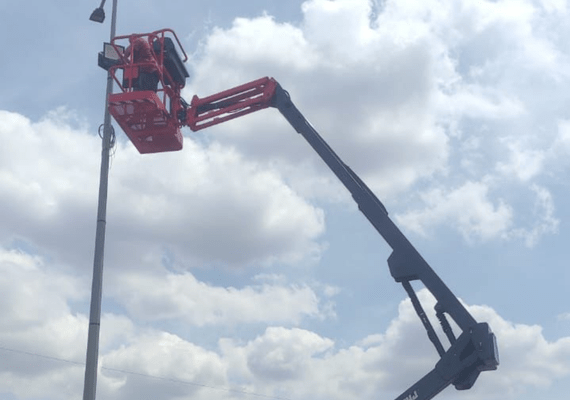 Electric scissor lift used for solar farm maintenance and solar panel installation
